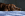 perro marrón tumbado sobre una manta azul