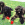 Drie zwarte honden zitten in het gras, elk met een KONG Classic.