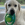 Um cão branco com um brinquedo KONG na boca.